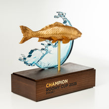Load image into Gallery viewer, Trophy with a gold fish and wooden base on a white background