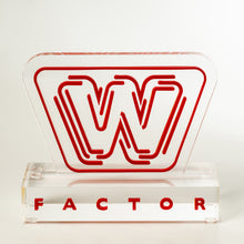 Load image into Gallery viewer, Red 'W' logo on a clear base with 'FACTOR' below on a white background