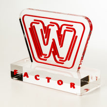 Load image into Gallery viewer, Clear acrylic block with red 'W' logo and 'FACTOR' text on a white background