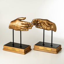 Load image into Gallery viewer, Bronze hand sculptures on black stands with wooden bases against a white background