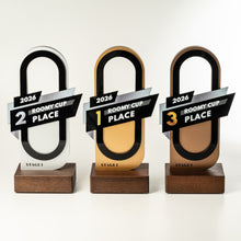 Load image into Gallery viewer, Three award-style trophy plaques for '2026 Roomy Cup' are shown on a clean white background. Each plaque has an arched transparent section with a different base color: white for 2nd place, gold for 1st place, and bronze for 3rd place, mounted on dark wood bases.